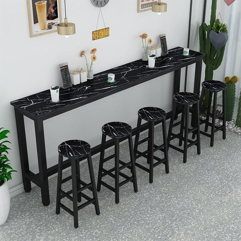 tall narrow table with stools